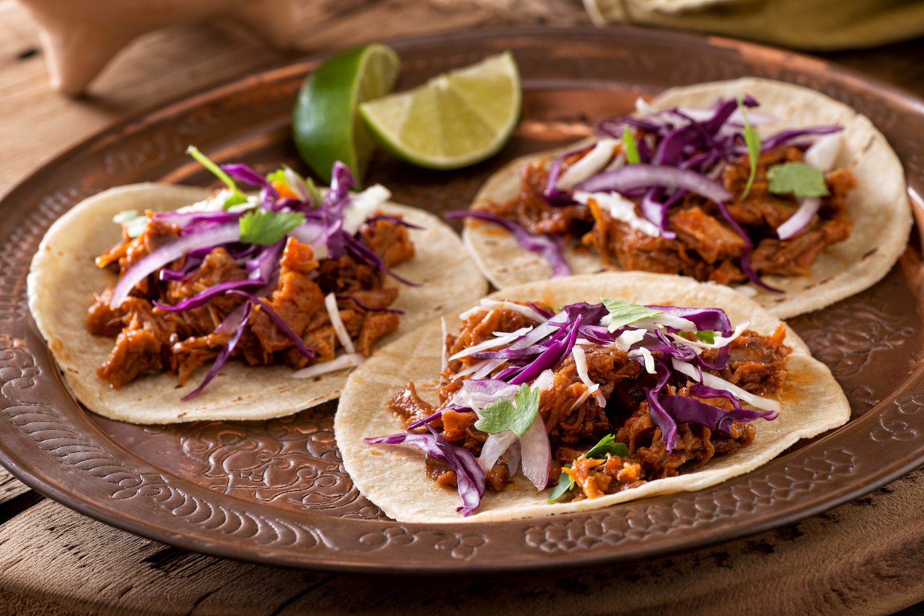 Three,Delicious,Pulled,Pork,Tacos,With,Cabbage,,Onion,And,Cilantro. pulled pork tacos